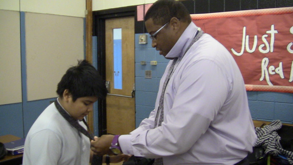 Omega Psi Phi Fraternity (Jersey Shore Ques) at teaches kids how to tie a tie at Asbury Park Middle School